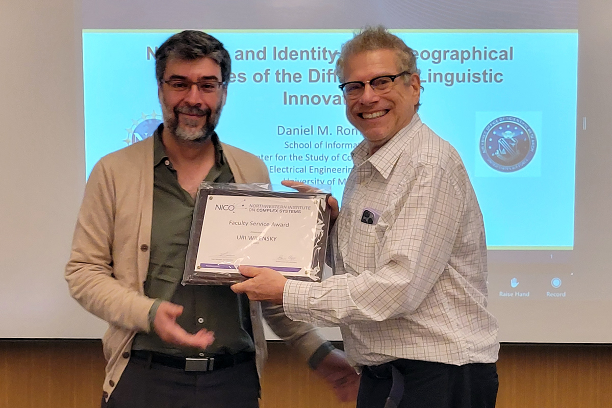 Luis Amaral presents the Faculty Service Award to Uri Wilensky. Photo by Alanna Lazarowich.